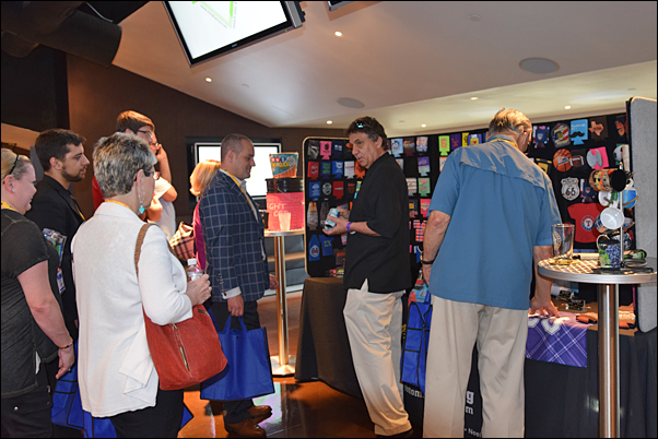 Tony Pinto (center) explains the features of a BEST Promotions USA product to a group of buyers and their distributors at the MLR Alliance event.